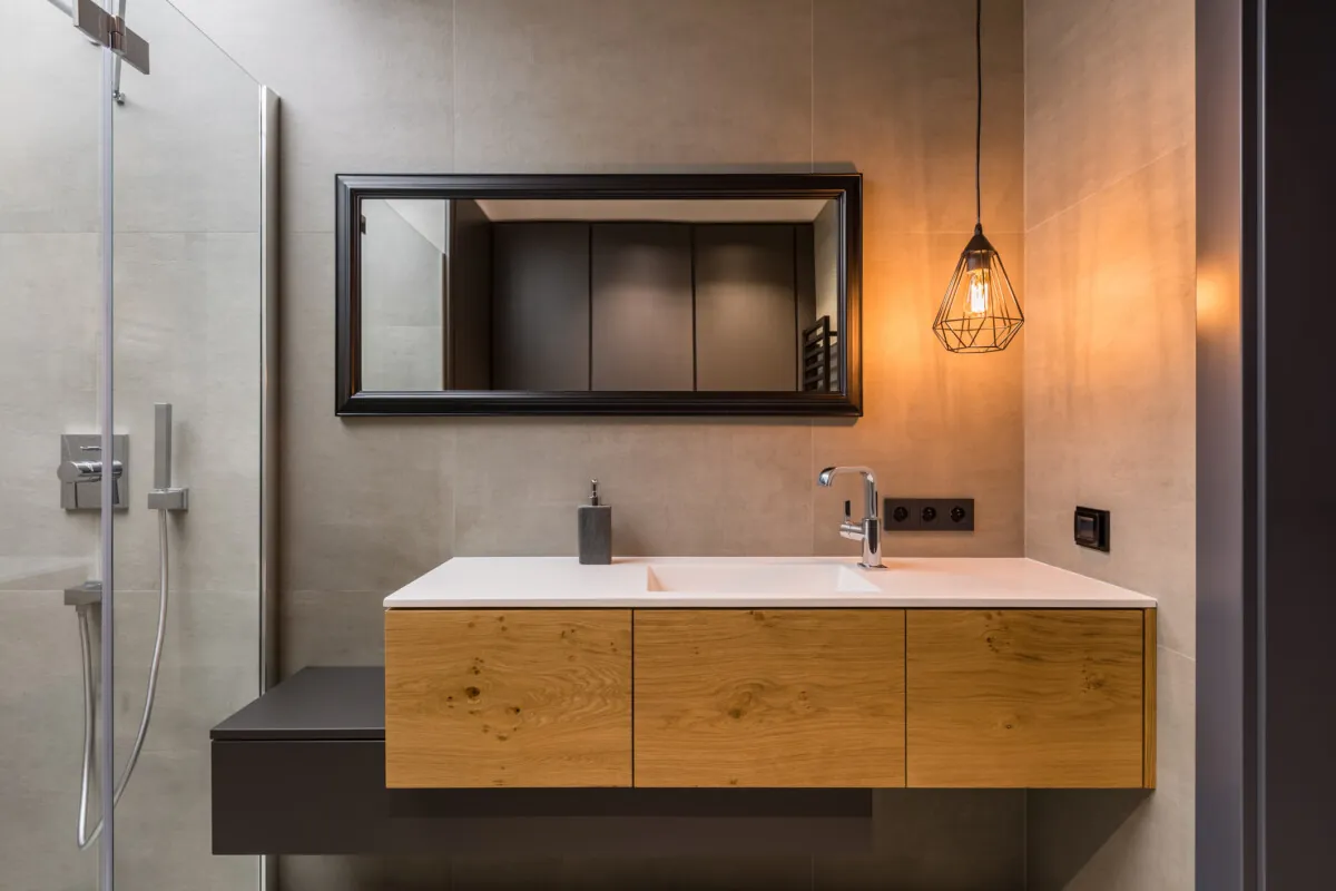 Integral countertop sink on wooden cabinets in contemporary bathroom