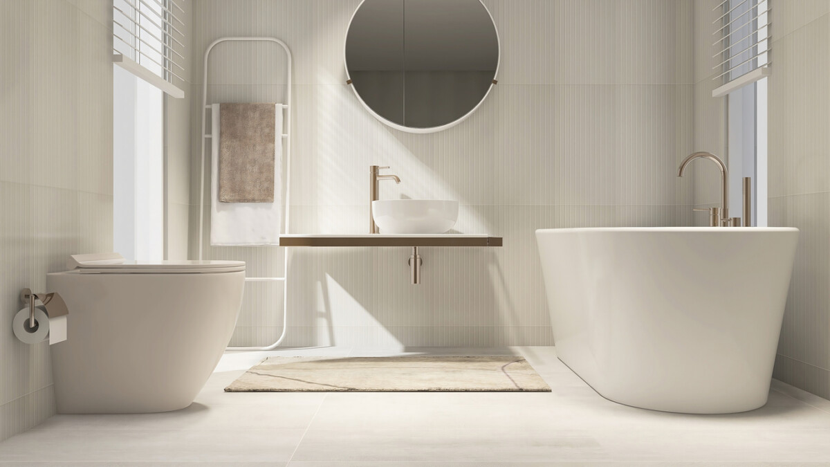 Luxury cream-white bathroom with modern toilet, vanity counter, and freestanding bathtub.